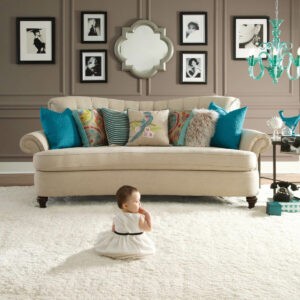 Cute baby sitting on bright carpet | Floor Systems